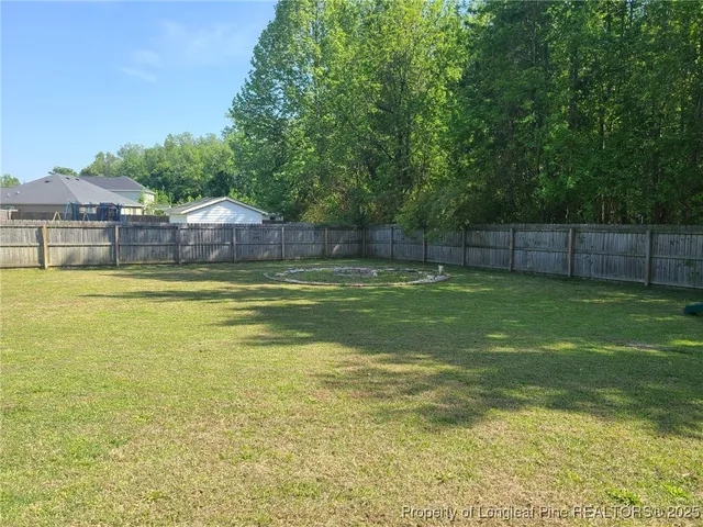 a view of a swimming pool with a yard