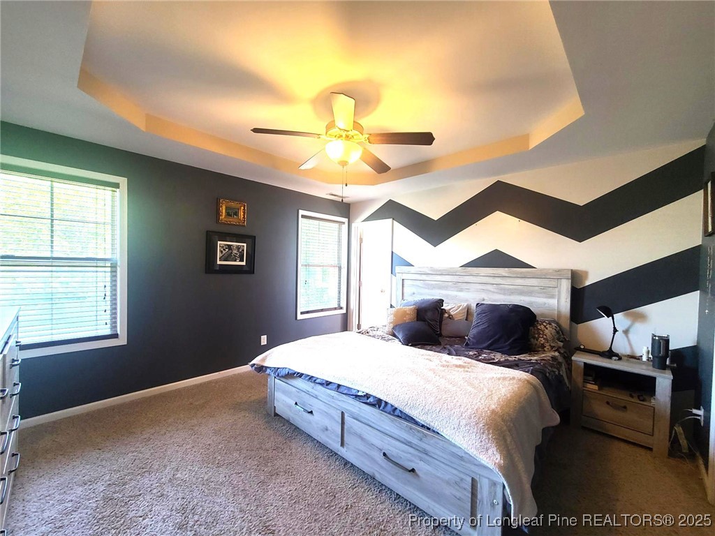 139 Spillburg Court Raeford, NC 28376 - Photo 19 of 33 a bedroom with a bed and a chandelier