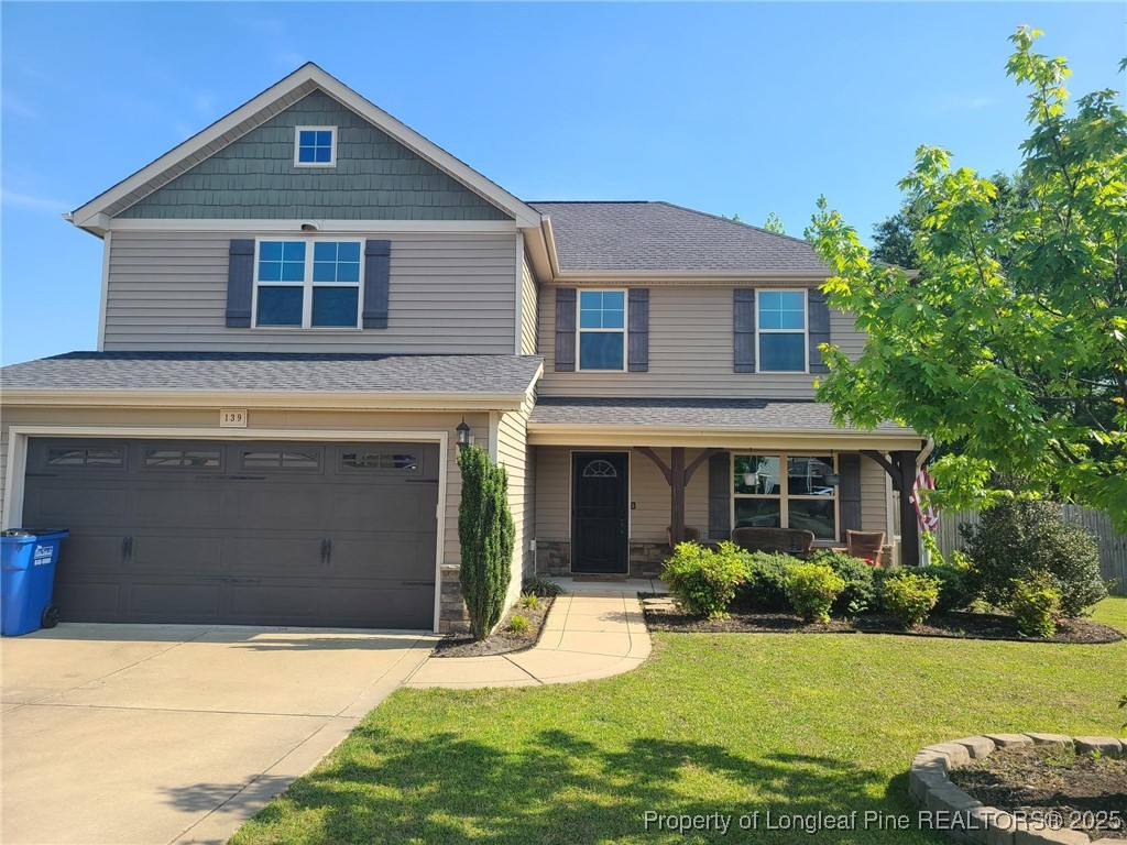 139 Spillburg Court Raeford, NC 28376 - Photo 2 of 33 a front view of a house with a yard and garage