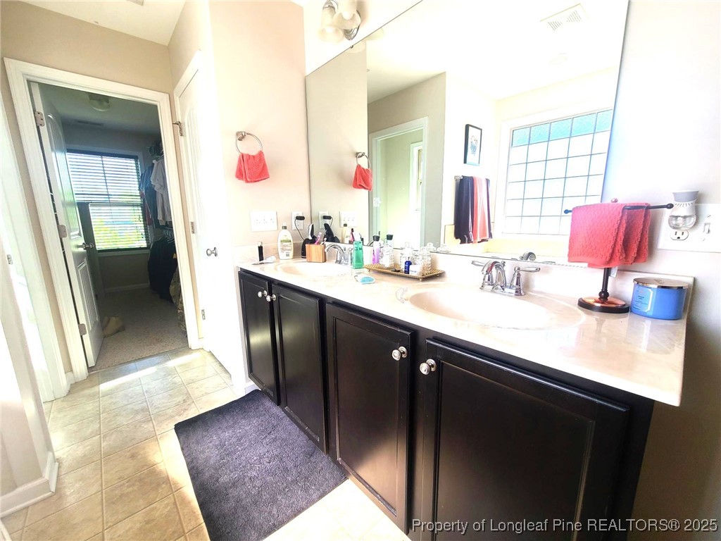 139 Spillburg Court Raeford, NC 28376 - Photo 23 of 33 a en suite bathroom with a sink and a mirror