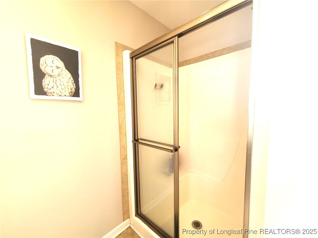 139 Spillburg Court Raeford, NC 28376 - Photo 24 of 33 a bathroom with a glass shower door