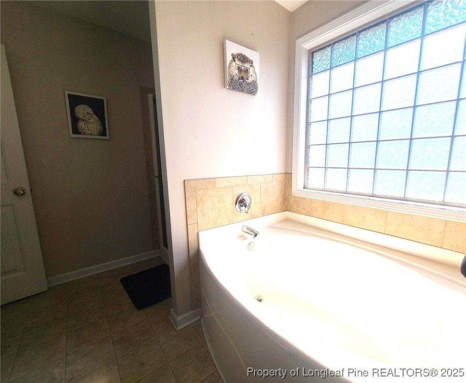 139 Spillburg Court Raeford, NC 28376 - Photo 25 of 33 a bathroom with a bathtub and next to a window