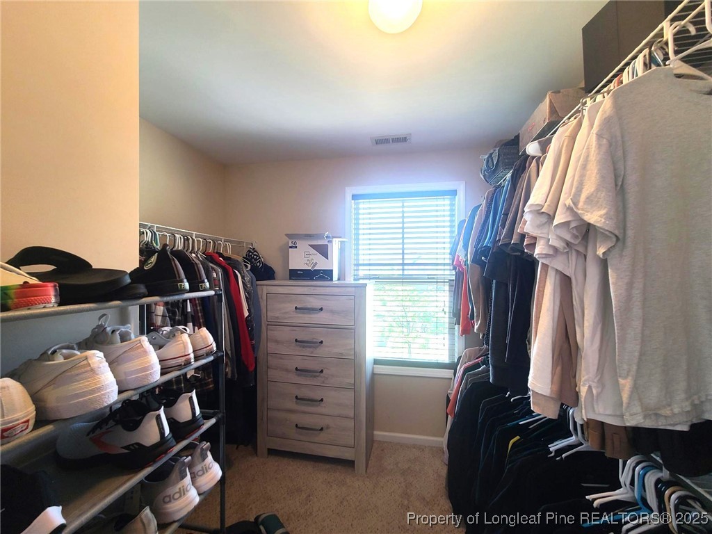 139 Spillburg Court Raeford, NC 28376 - Photo 26 of 33 a view of walk in closet with clothes and shoes
