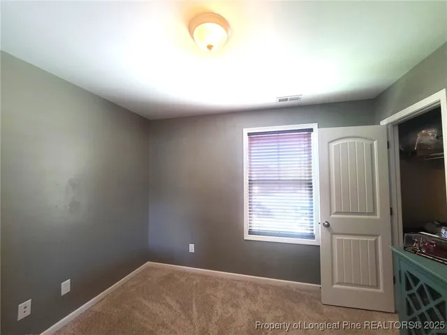 a view of a livingroom with an empty space and a window