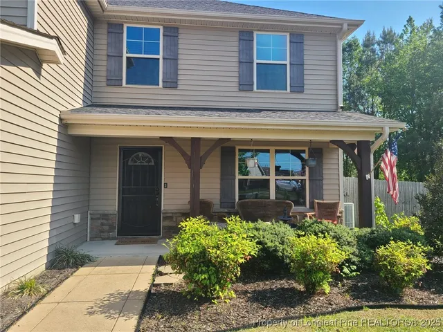 a front view of a house with garden
