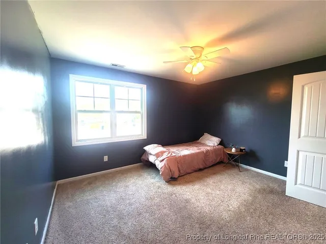 a bed room with a bed and a window