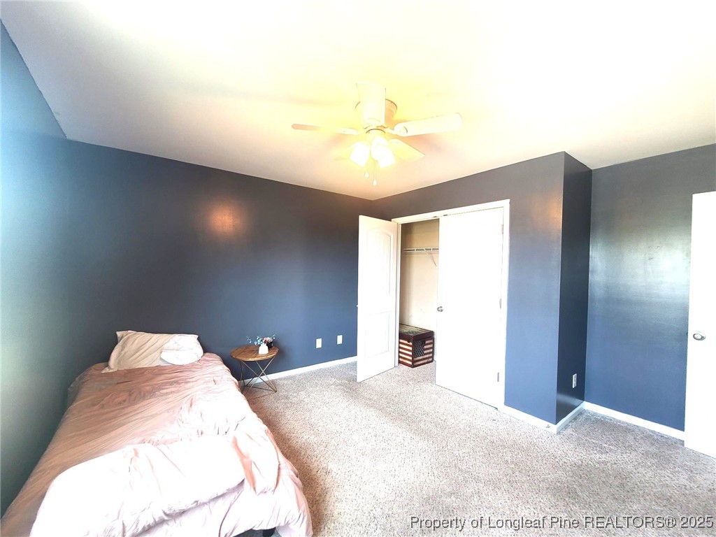 139 Spillburg Court Raeford, NC 28376 - Photo 32 of 33 a bedroom with a bed and a chandelier