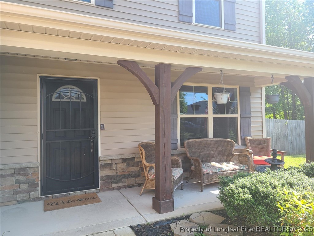 139 Spillburg Court Raeford, NC 28376 - Photo 4 of 33 a front view of a house with outdoor seating and a potted plant