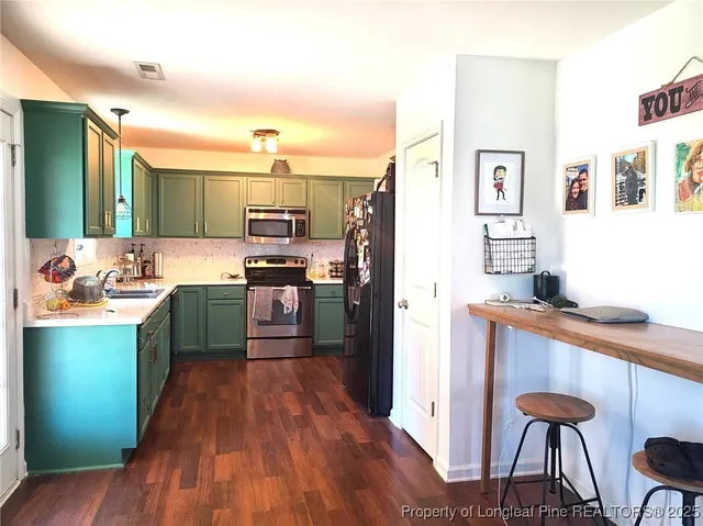 a kitchen with stainless steel appliances a stove top oven a sink dishwasher and a refrigerator