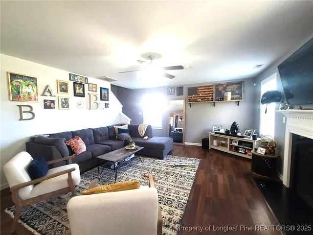 a living room with furniture fireplace and a window