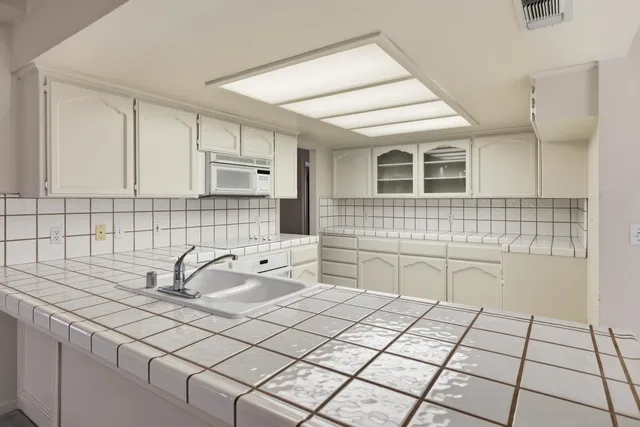 a kitchen with a sink and cabinets