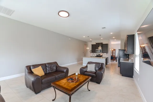 a living room with furniture and a piano