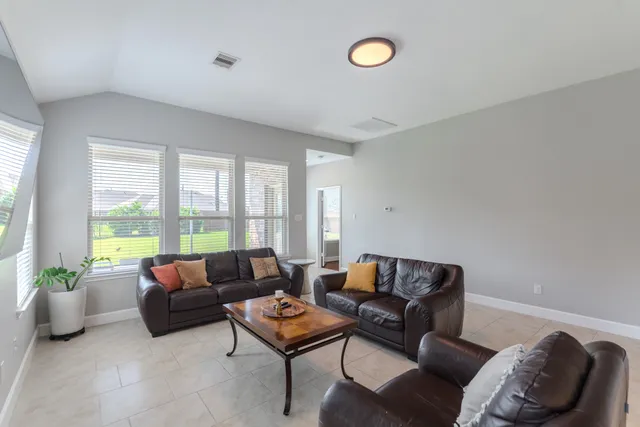 a bedroom with a bed and a chair