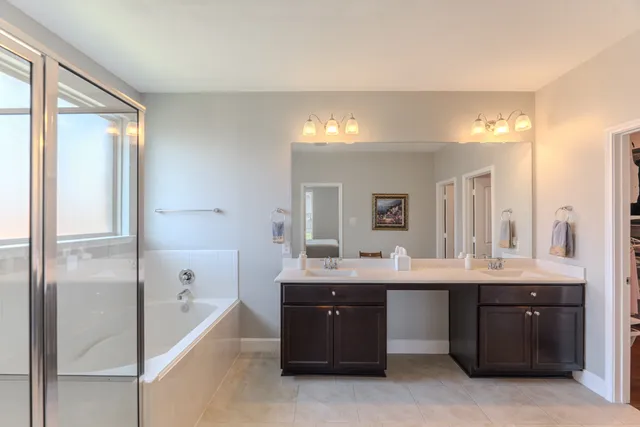 a view of walk in closet with wooden floor