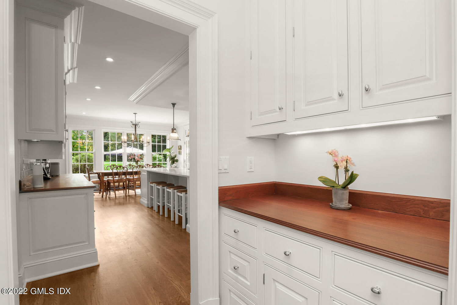 33 Hill Road Greenwich, CT 06830 - Photo 16 of 49 a kitchen with white cabinets and chandelier