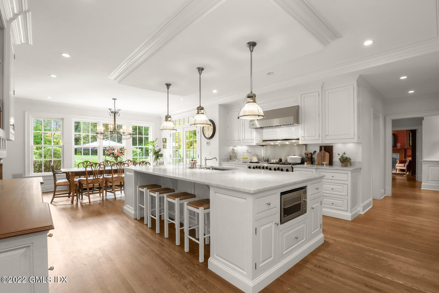 33 Hill Road Greenwich, CT 06830 - Photo 10 of 49 a kitchen with stainless steel appliances granite countertop a stove a sink dishwasher a refrigerator and a dining table with wooden floor