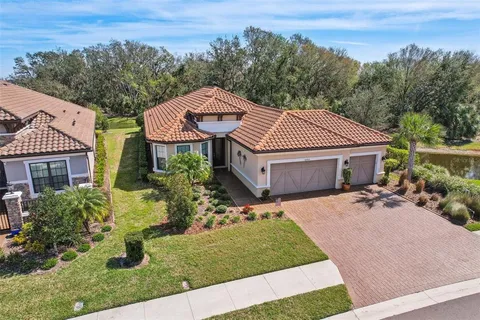 an aerial view of a backyard with swimming pool and outdoor seating