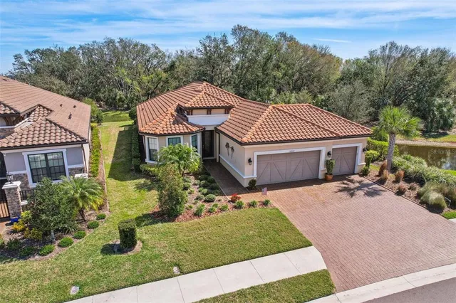 an aerial view of a backyard with swimming pool and outdoor seating