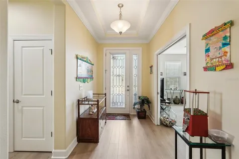 a living room with furniture a flat screen tv and a floor to ceiling window