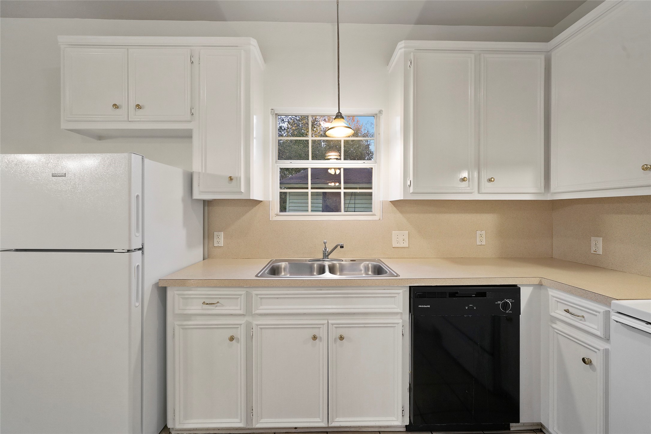 5502 Finch Street, Unit B Houston, TX 77028 - Photo 14 of 37 a kitchen with white cabinets and white appliances
