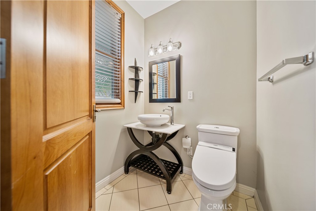 216 North Buena Vista Street Burbank, CA 91505 - Photo 6 of 22 a bathroom with a toilet a sink and a mirror