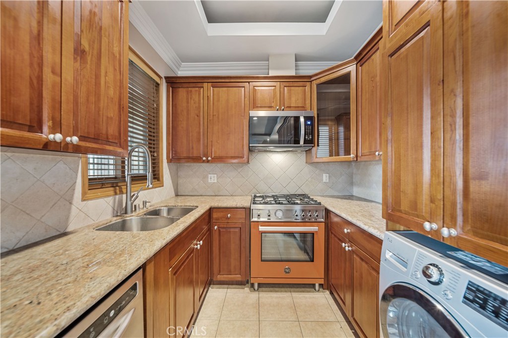 216 North Buena Vista Street Burbank, CA 91505 - Photo 8 of 22 a kitchen with stainless steel appliances granite countertop a sink a stove and a wooden cabinets