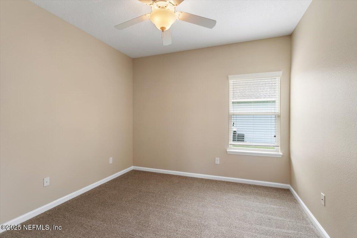 165 Crown Colony Road St. Augustine, FL 32092 - Photo 17 of 25 an empty room with a empty space and a window