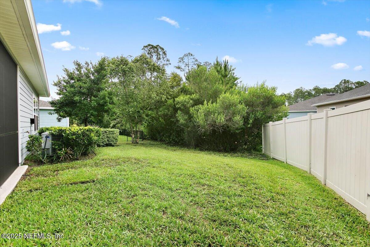 165 Crown Colony Road St. Augustine, FL 32092 - Photo 21 of 25 a backyard of a house with lots of green space