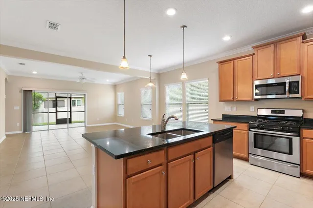 a kitchen with stainless steel appliances granite countertop a sink a stove and a granite counter tops