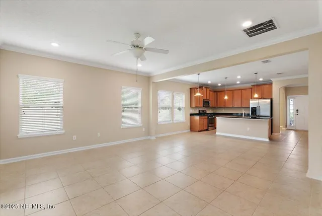a view of an empty room with a kitchen