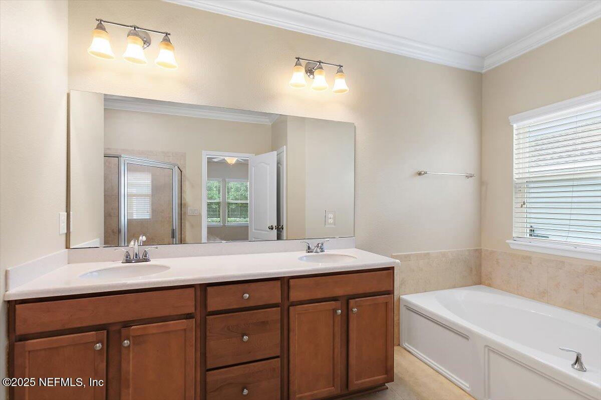 165 Crown Colony Road St. Augustine, FL 32092 - Photo 10 of 25 a bathroom with a sink and a mirror