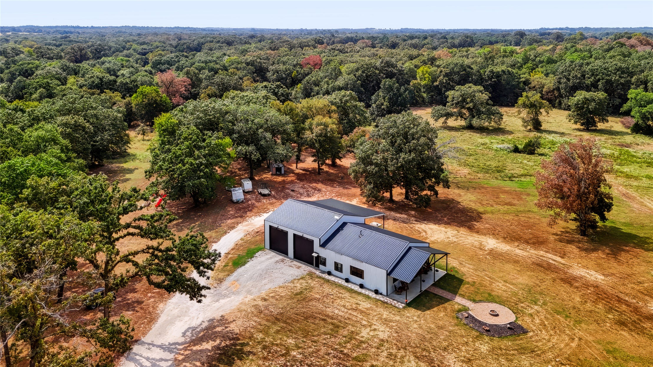 3607 South Half Bank Road Atoka, OK 74525 - Photo 7 of 82 Modern barn-style residence with a dark metal roof and light-colored siding