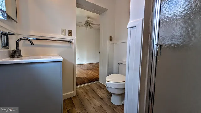 a bathroom with a sink toilet and a mirror