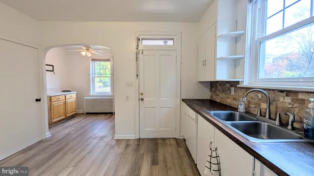 a kitchen with sink a window and cabinets