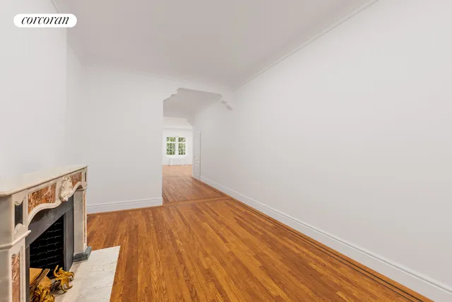 a living room with patio furniture and a chandelier
