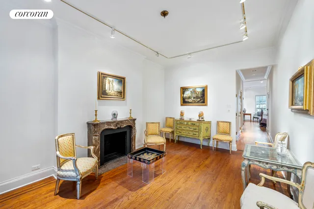 a view of empty room with wooden floor and fireplace