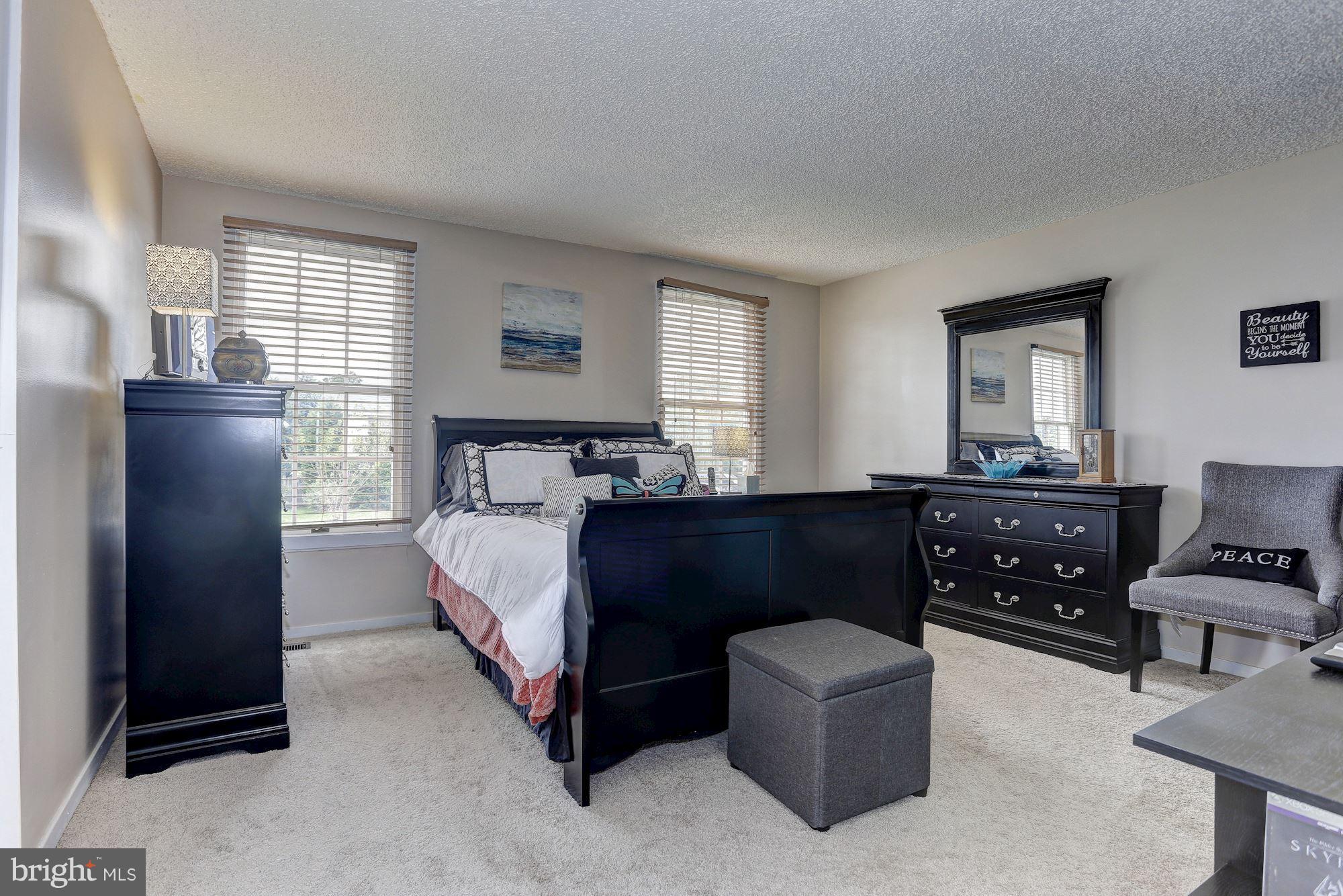 2302 Crossett Road Baltimore, MD 21237 - Photo 25 of 30 a bedroom with a bed and wooden floor
