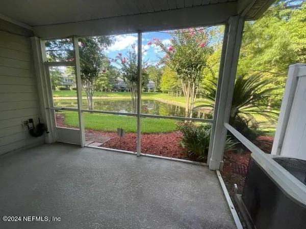 a view of a room with wooden floor and windows