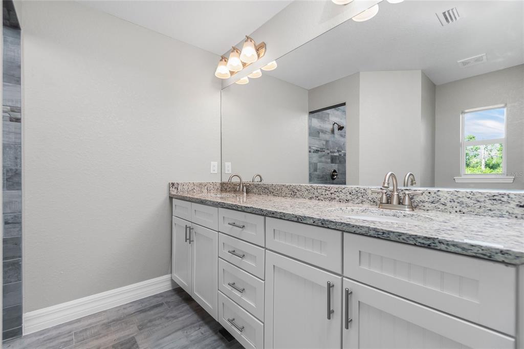 6 Cockpit Lane Placida, FL 33946 - Photo 15 of 20 a bathroom with a granite countertop sink and a mirror