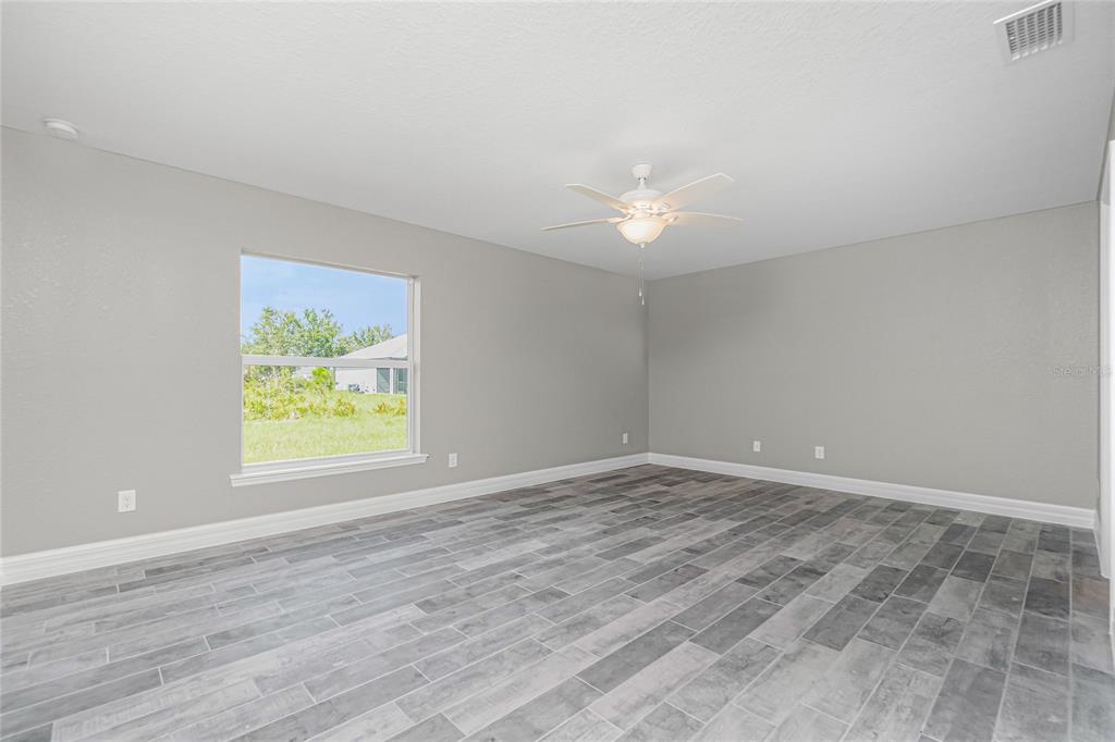 6 Cockpit Lane Placida, FL 33946 - Photo 17 of 20 a view of an empty room with a window and wooden floor