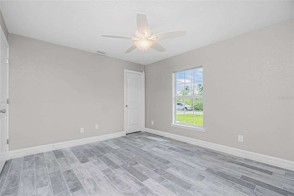 6 Cockpit Lane Placida, FL 33946 - Photo 5 of 20 wooden floor in an empty room with a window