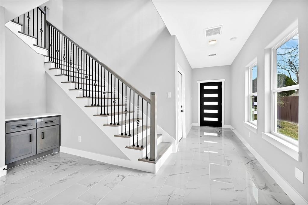 7517 Hezekiah Lane, Unit B Houston, TX 77088 - Photo 3 of 13 a view of a hallway with stairs and windows