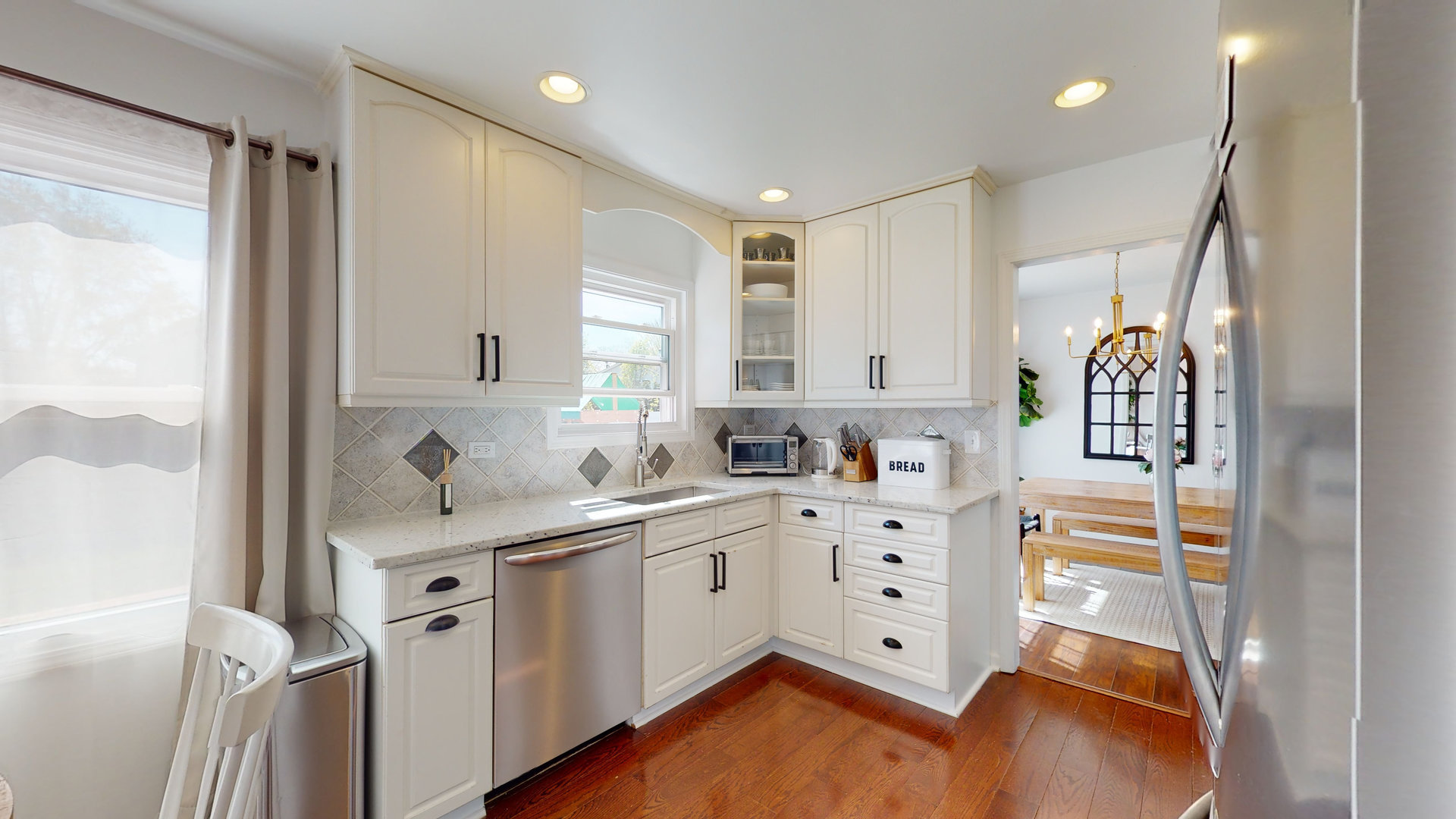 1017 Weeping Willow Drive Wheeling, IL 60090 - Photo 5 of 34 a kitchen with stainless steel appliances cabinets a wooden floor and a window