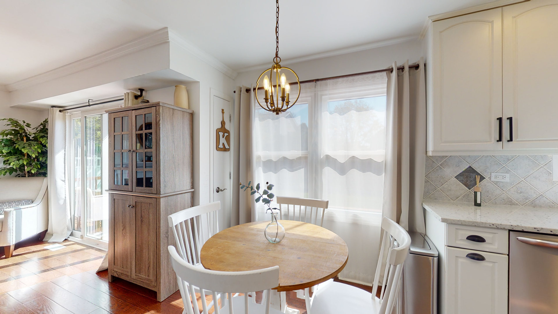 1017 Weeping Willow Drive Wheeling, IL 60090 - Photo 7 of 34 a dining room with furniture a chandelier and wooden floor