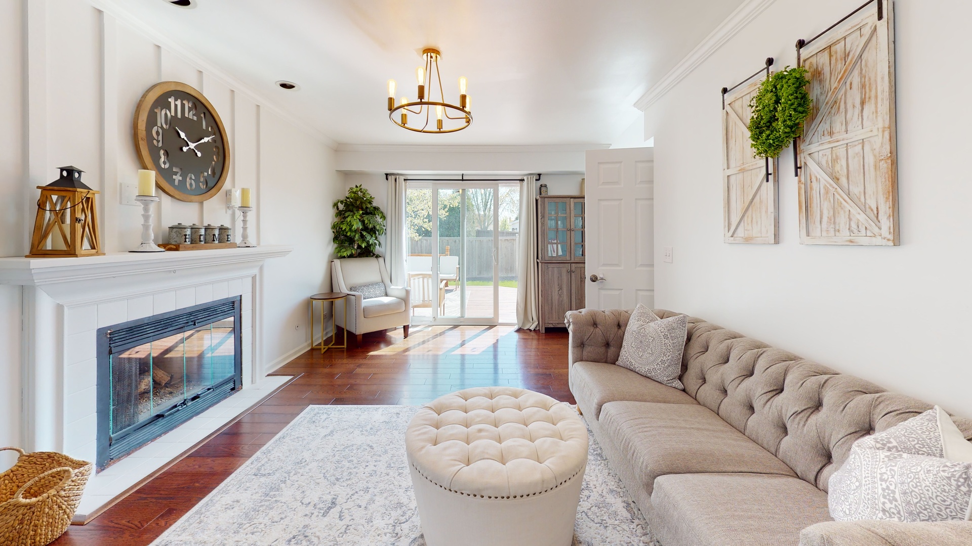 1017 Weeping Willow Drive Wheeling, IL 60090 - Photo 8 of 34 a living room with furniture a clock and a fireplace