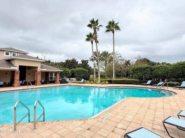 a swimming pool with outdoor seating and yard