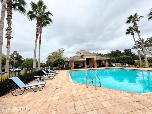a view of a house with swimming pool and sitting area