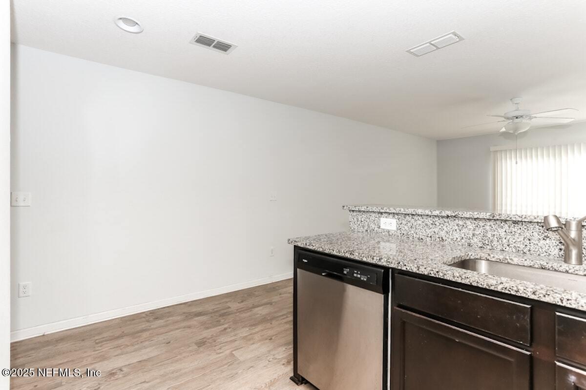 514 Eiseman Way Jacksonville, FL 32216 - Photo 5 of 15 a room with granite countertop cabinets a sink and dishwasher