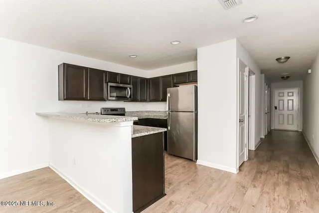 a kitchen with a refrigerator and a microwave