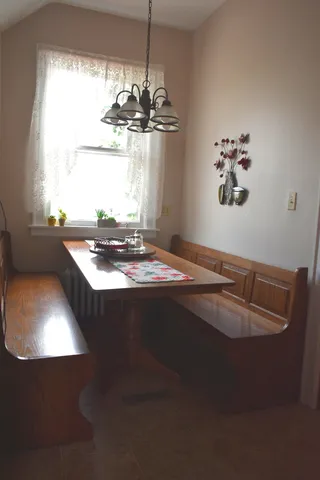 a dining room with furniture and window